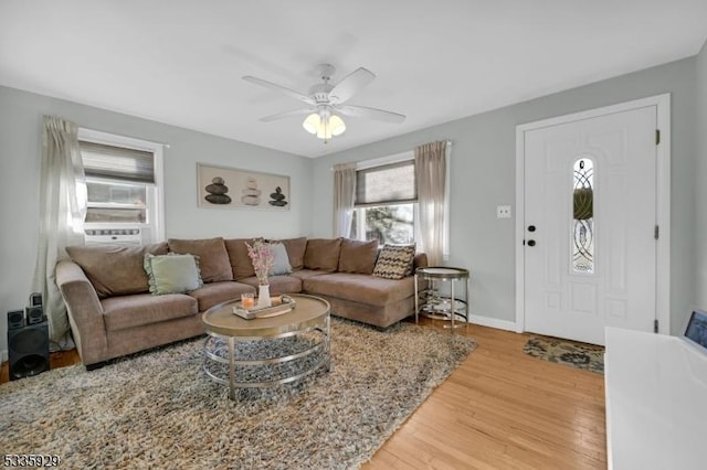 living room with ceiling fan and hardwood / wood-style floors