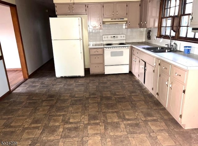 kitchen with sink, white appliances, and decorative backsplash