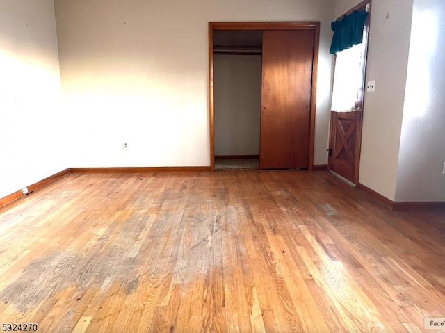 unfurnished bedroom with hardwood / wood-style flooring and a closet