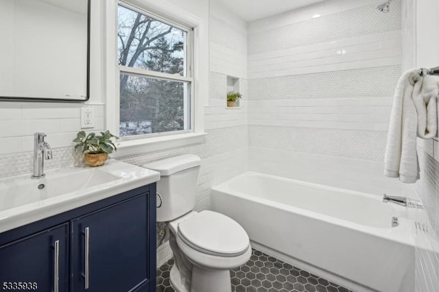 bathroom featuring vanity, toilet, and backsplash