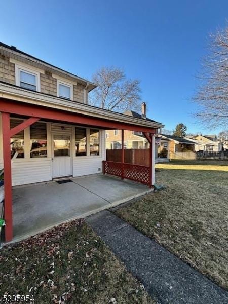 view of property exterior featuring a lawn and a patio