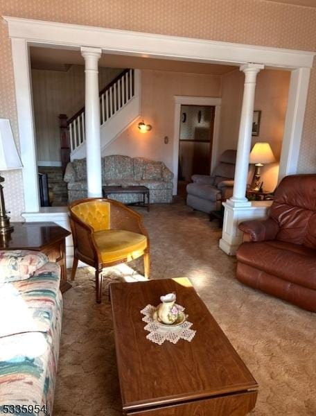 living room featuring decorative columns and carpet