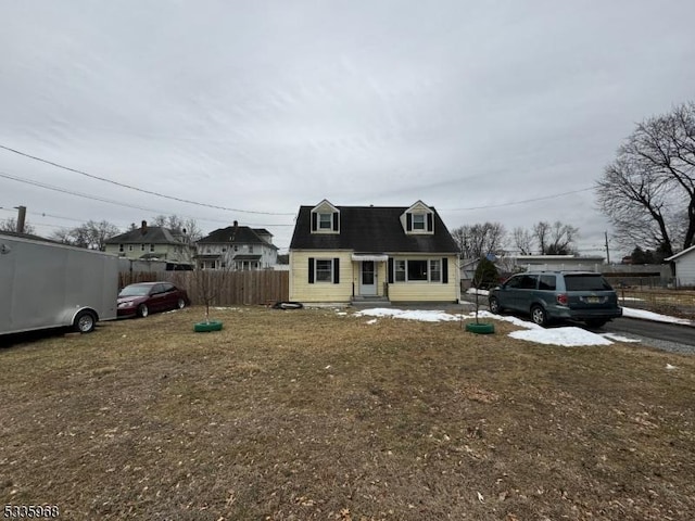 new england style home with a front yard