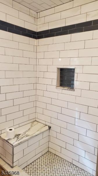 bathroom with a tile shower