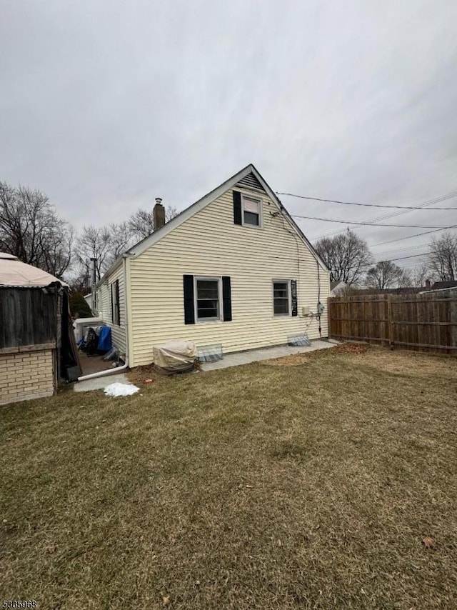 rear view of house with a yard