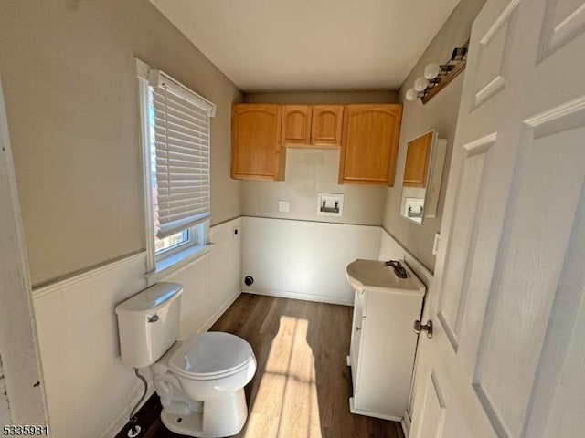 clothes washing area with hookup for a washing machine and dark wood finished floors