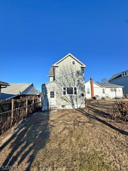 back of house with entry steps and fence