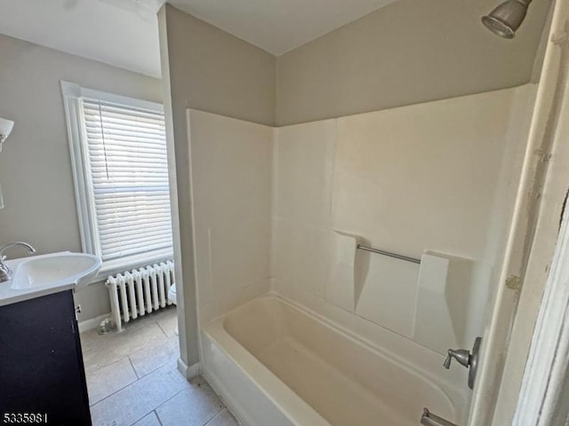 bathroom with shower / bath combination, radiator heating unit, vanity, tile patterned flooring, and baseboards