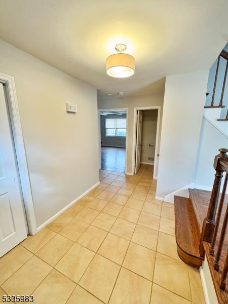 hall with light tile patterned flooring