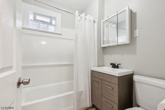 bathroom with shower / bath combo, vanity, and toilet