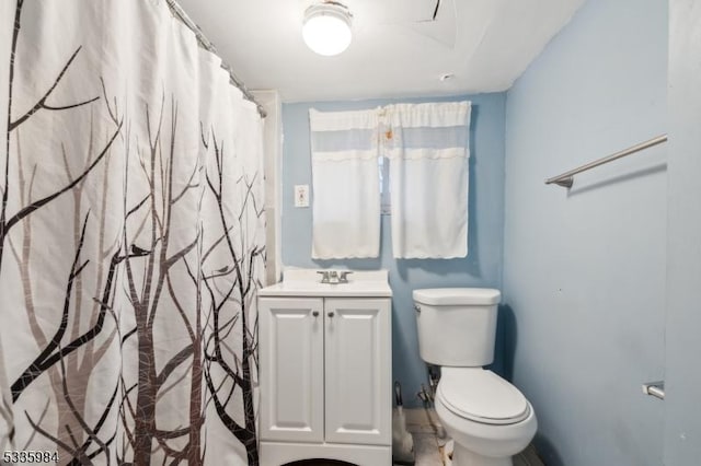 bathroom featuring toilet and vanity