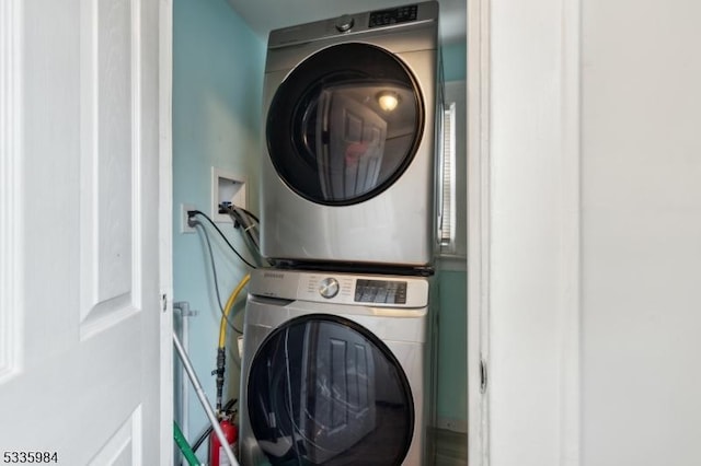 laundry area with laundry area and stacked washer / dryer