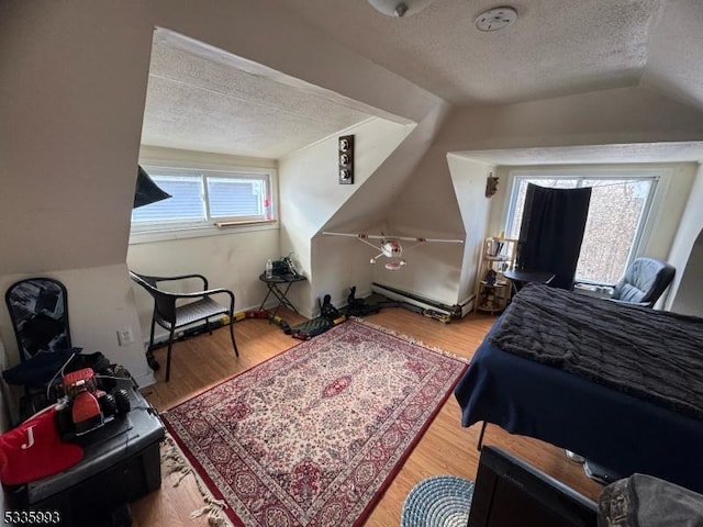 bedroom featuring hardwood / wood-style floors, vaulted ceiling, a textured ceiling, and baseboard heating