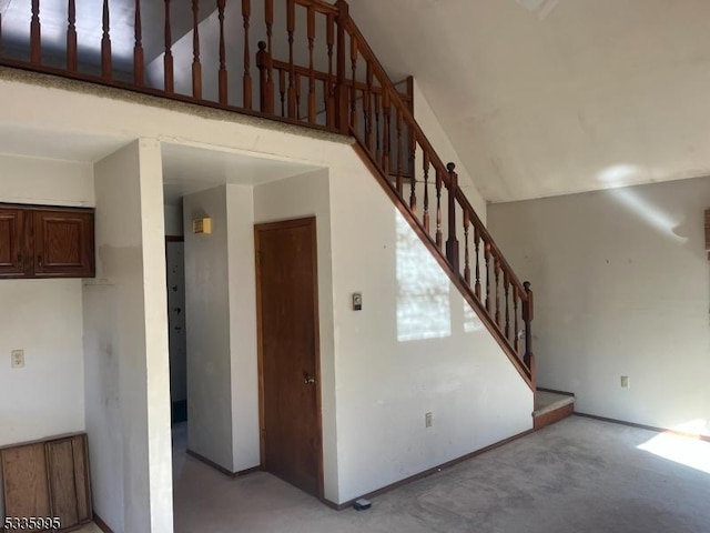 staircase featuring a towering ceiling