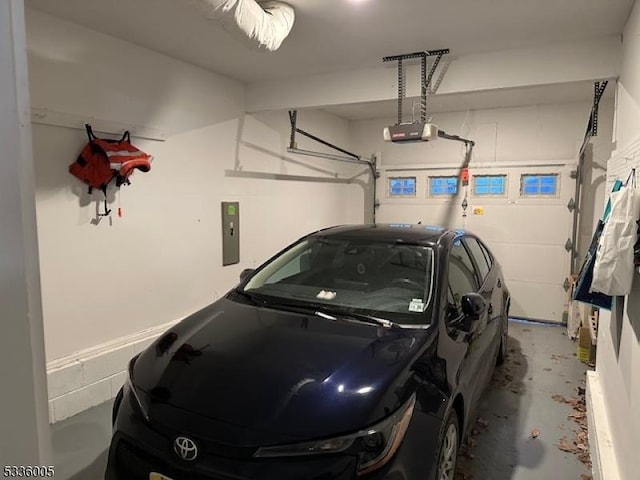 garage featuring a garage door opener and electric panel