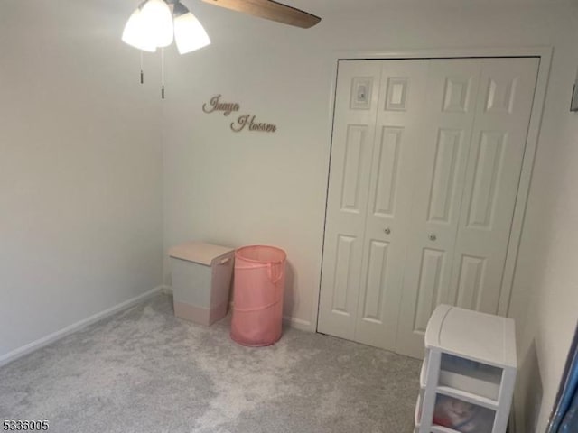 recreation room with ceiling fan and light colored carpet