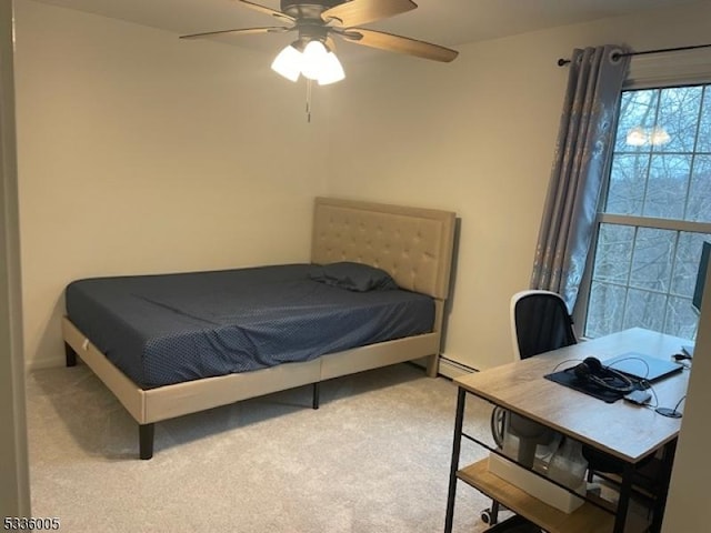 bedroom featuring baseboard heating, ceiling fan, and carpet floors