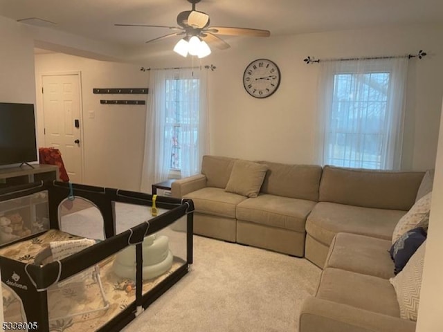 carpeted living room featuring ceiling fan