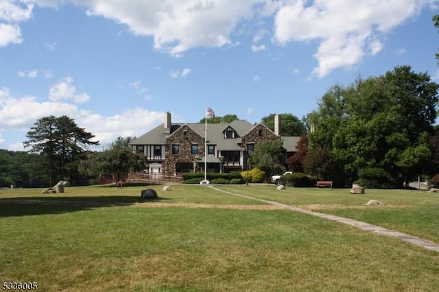 view of home's community with a lawn