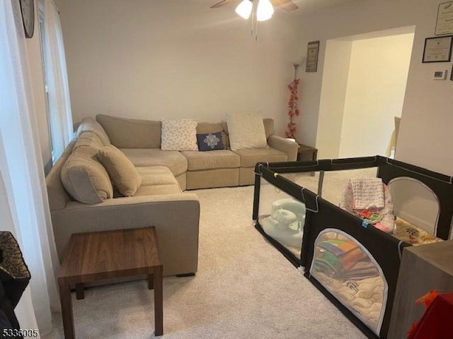 living room with carpet and ceiling fan