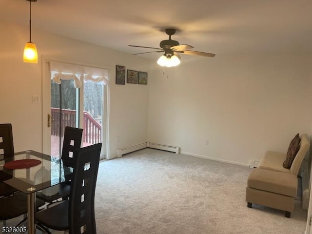 carpeted dining area featuring a baseboard radiator and ceiling fan