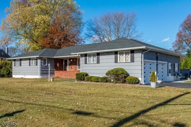 ranch-style house with a garage and a front yard