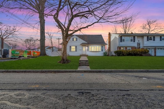 view of front of property with a yard and a garage