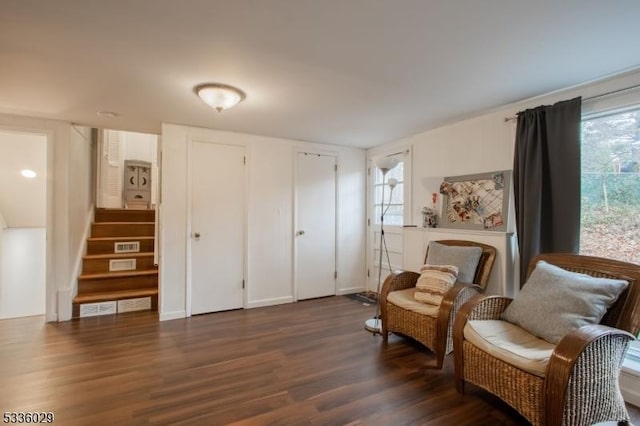 living area featuring dark wood-style floors and stairway