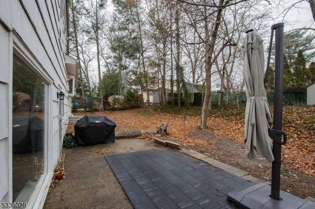 view of patio / terrace with area for grilling and fence