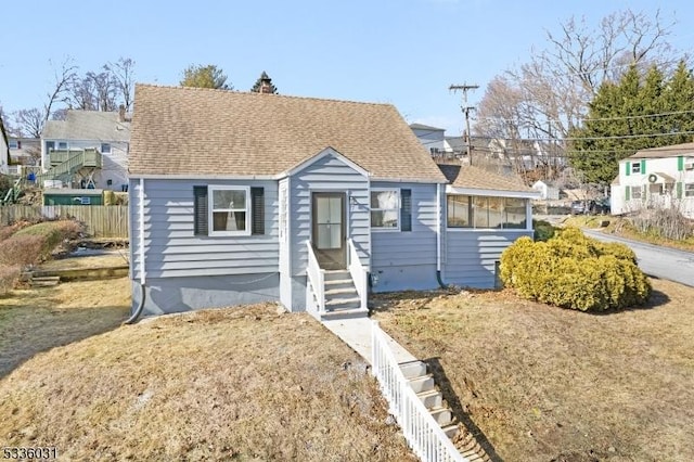 bungalow-style house with a front yard