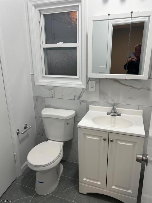 bathroom with vanity, tile patterned floors, and toilet