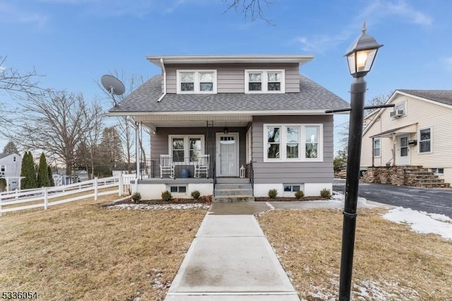 bungalow-style home with a porch and a front yard