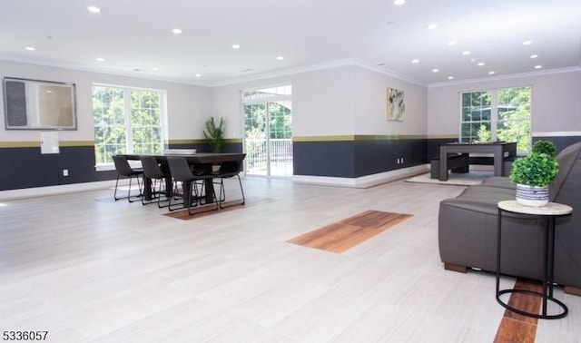 living room with crown molding and plenty of natural light