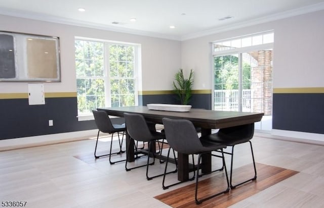 dining area featuring crown molding