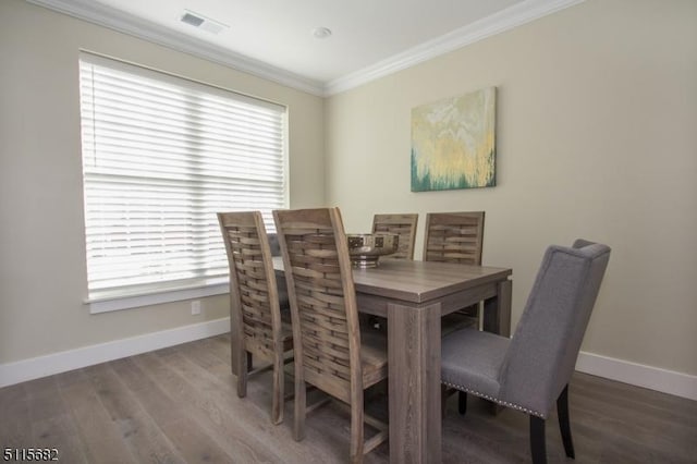 dining space with hardwood / wood-style flooring and ornamental molding