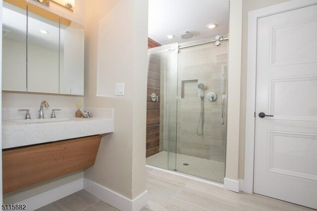 bathroom featuring vanity and an enclosed shower