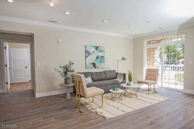 living room with ornamental molding and dark hardwood / wood-style floors