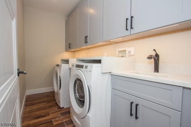 washroom featuring cabinets, washer and clothes dryer, and sink