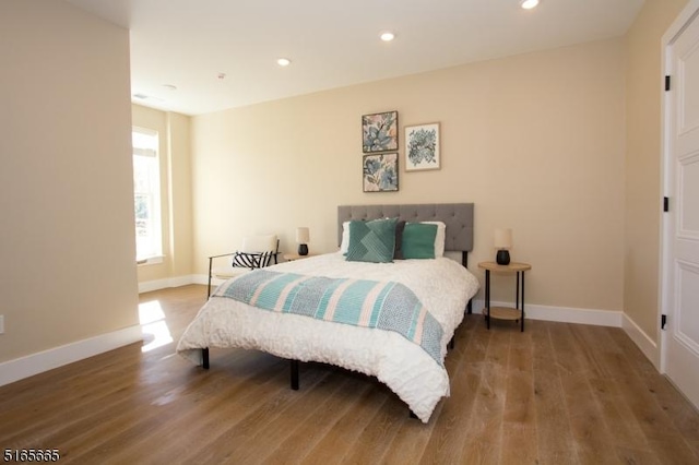 bedroom with wood-type flooring