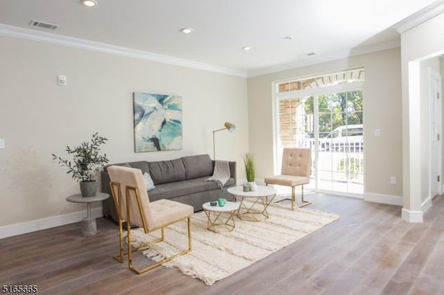 living room with ornamental molding and hardwood / wood-style floors