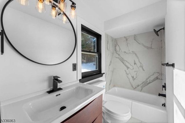 full bathroom featuring vanity, toilet, and tiled shower / bath combo