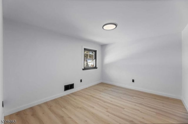 spare room featuring light wood-type flooring