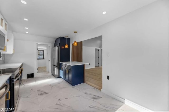 kitchen with appliances with stainless steel finishes, blue cabinets, white cabinetry, a kitchen breakfast bar, and hanging light fixtures