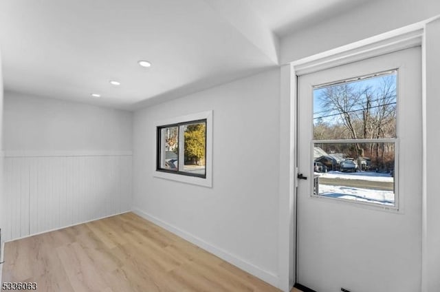 doorway to outside with a healthy amount of sunlight and light hardwood / wood-style floors