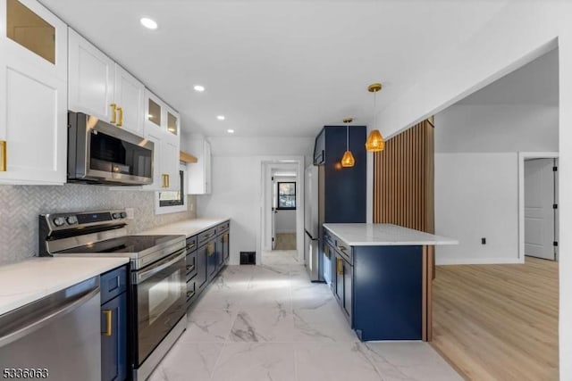 kitchen featuring decorative light fixtures, tasteful backsplash, white cabinets, stainless steel appliances, and blue cabinetry