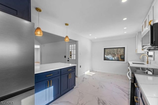 kitchen featuring appliances with stainless steel finishes, pendant lighting, blue cabinets, white cabinetry, and light stone counters