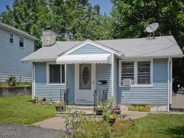 bungalow-style home with a front lawn