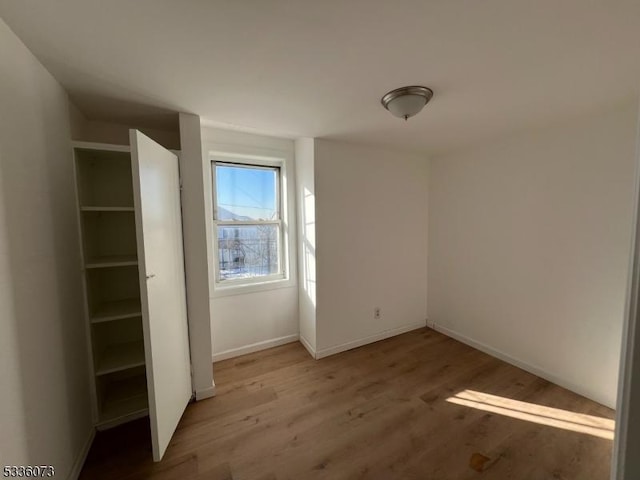 unfurnished bedroom with hardwood / wood-style floors