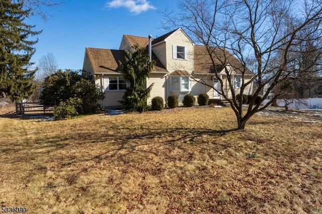 view of side of home with a lawn