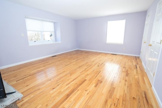 spare room with light hardwood / wood-style floors